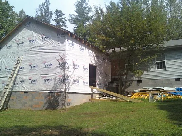 Tyvek wrapped gable on a new room addition beside an existing home in Bay Saint Louis